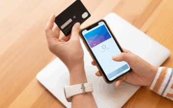 Person with a credit card and a smartphone.