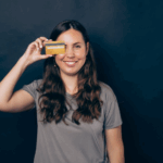 A woman holding a credit card.