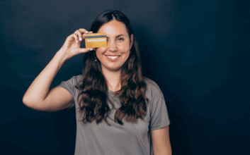 A woman holding a credit card.